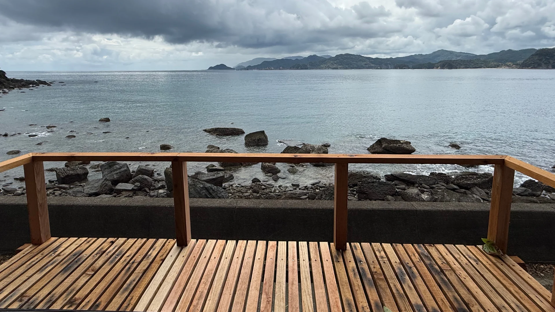 海と岩場を望む木製デッキ